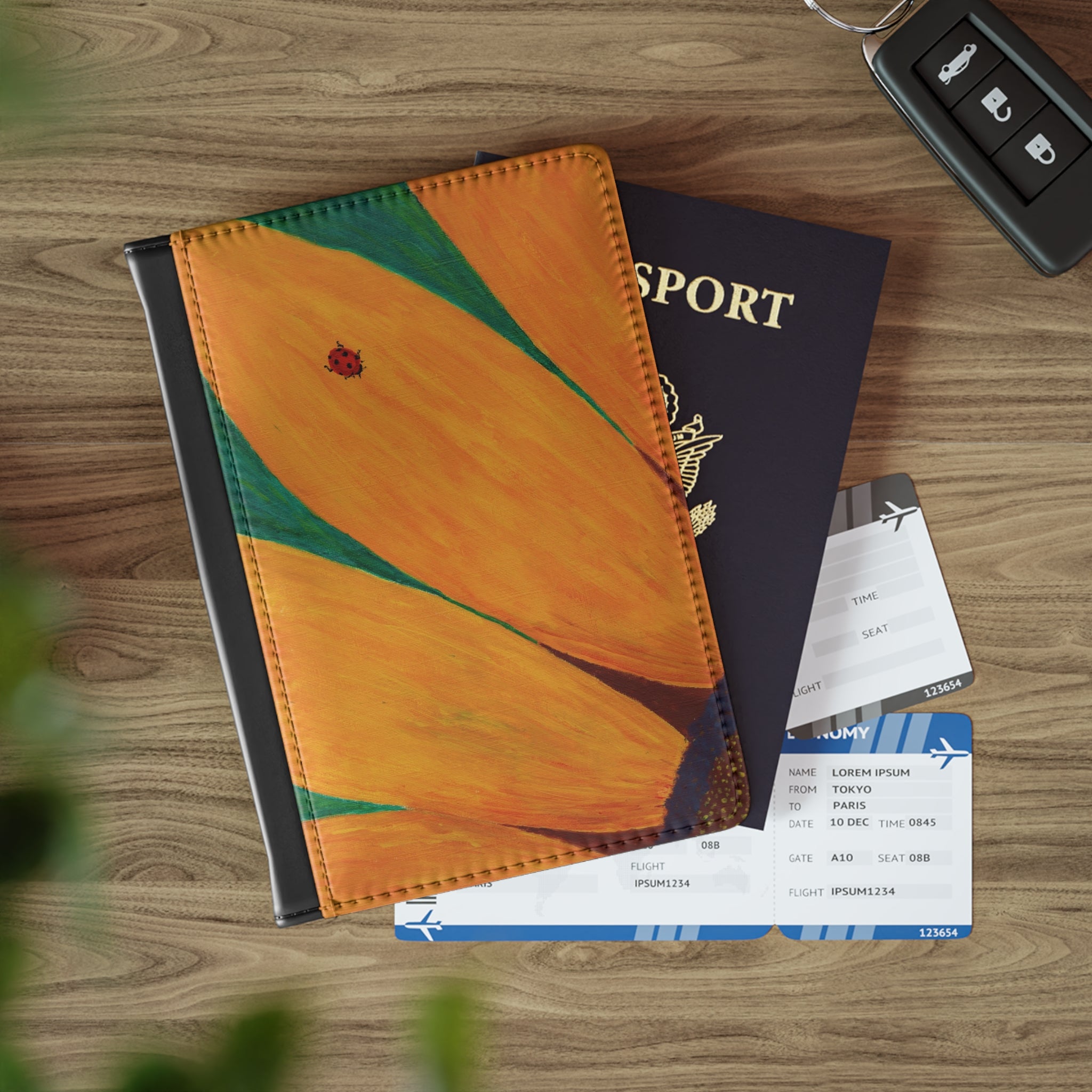 Passport with travel documents and a butterfly-themed notebook on a wooden surface