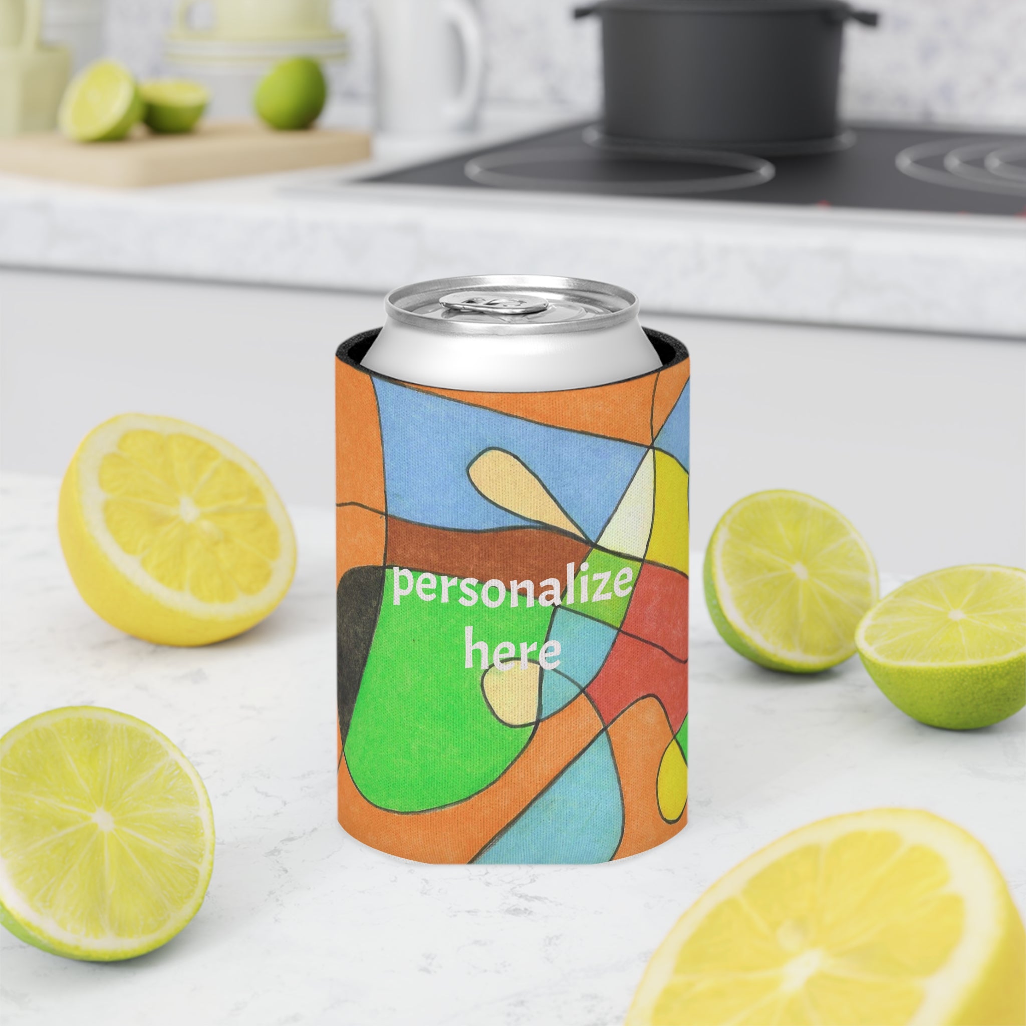 Colorful can cooler with 'personalize here' text on a kitchen counter with lemons and limes.