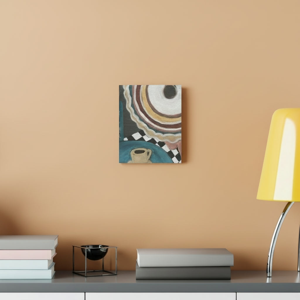 Woman's hat sitting at cafe with a yellow coffee cup painting on a wall above a shelf with books and a lamp.