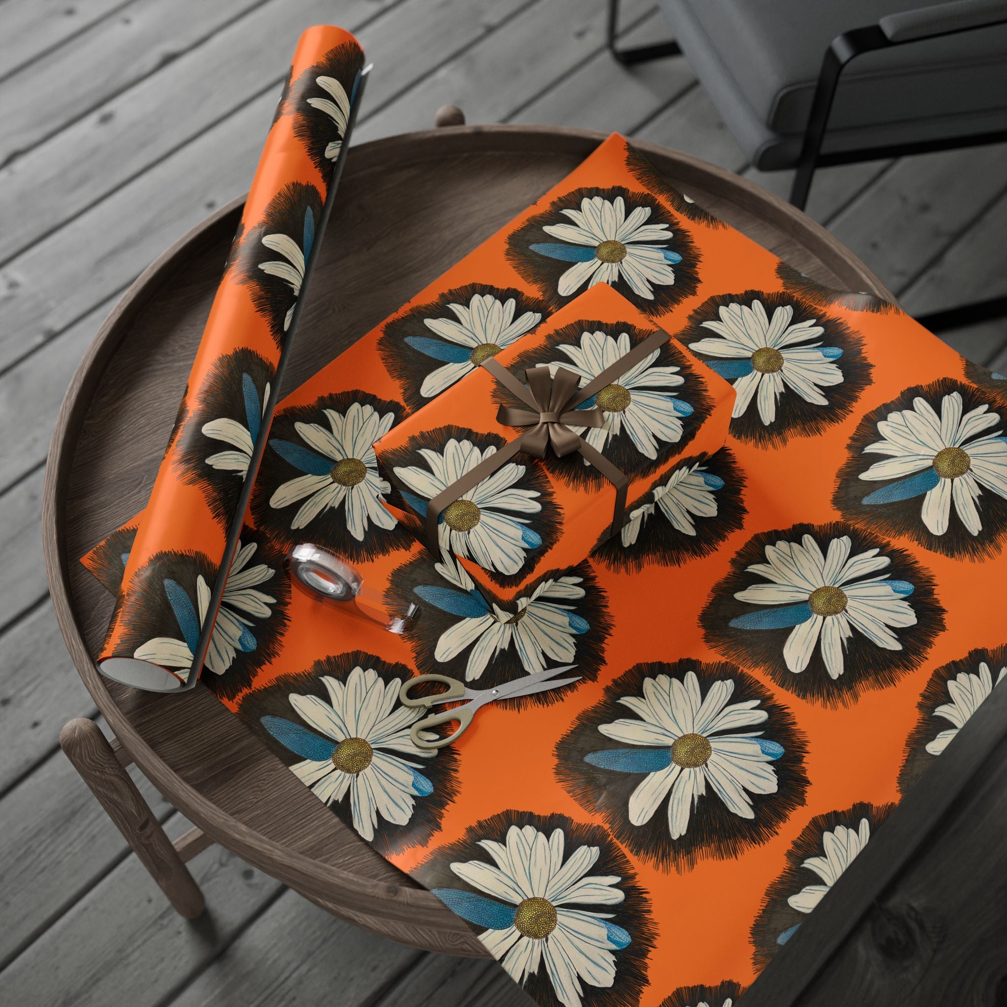 Floral-patterned tablecloth on a wooden table with a chair in the background