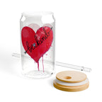 Clear glass tumbler with red heart design and 'be kind' text, accompanied by a straw and wooden lid on a white background.