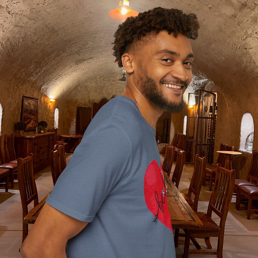 Man in a blue t-shirt with a red graphic in a rustic interior setting