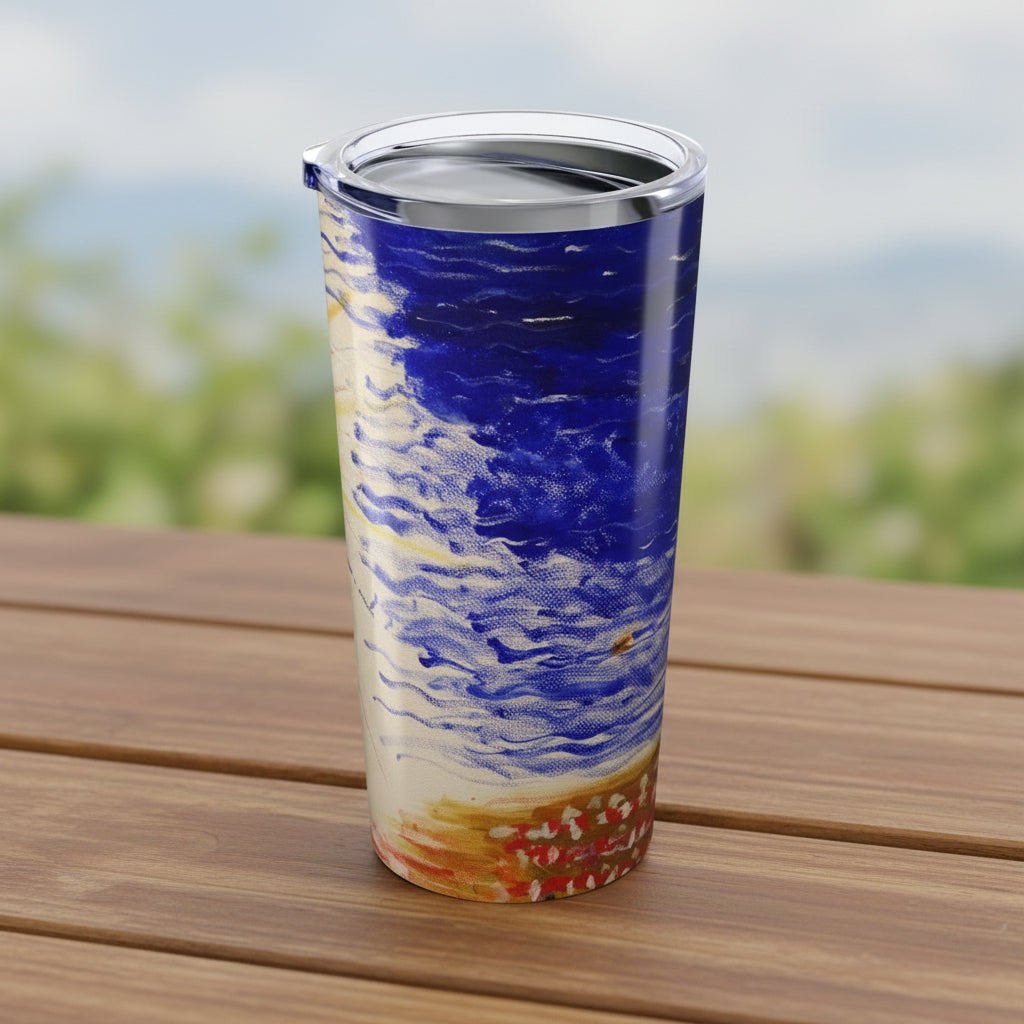 Tumbler with a blue and beige abstract design on a picnic table