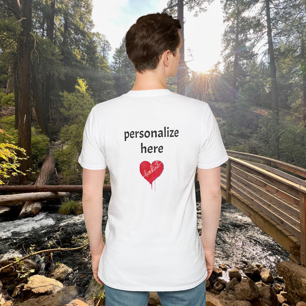 Person wearing a white t-shirt with customizable text and heart design in a forest setting
