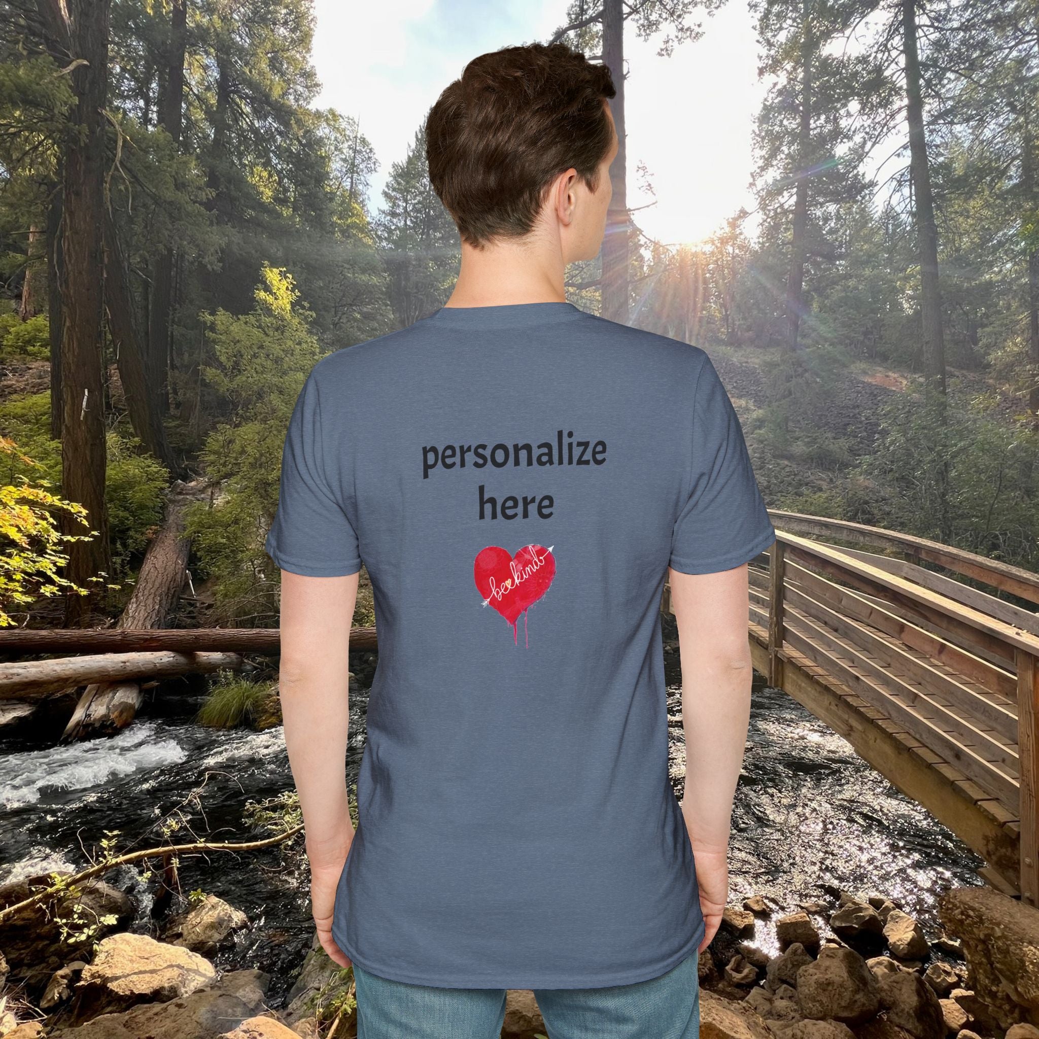 Person wearing a blue t-shirt with customizable text in a forest setting