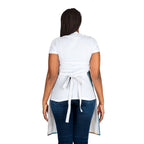 Person wearing a white apron over a white shirt and blue jeans on a white background