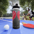 Water bottle with a design on a ping pong table with a blurred background of people playing.