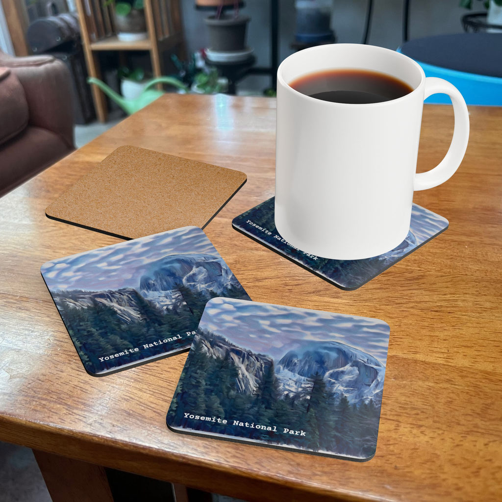 White mug with coffee on a wooden table with Yosemite National Park coasters.