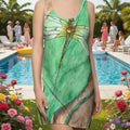 Green dress with dragonfly design worn by a model at a pool party