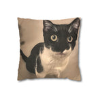 Pillow with a black and white cat design on a beige background