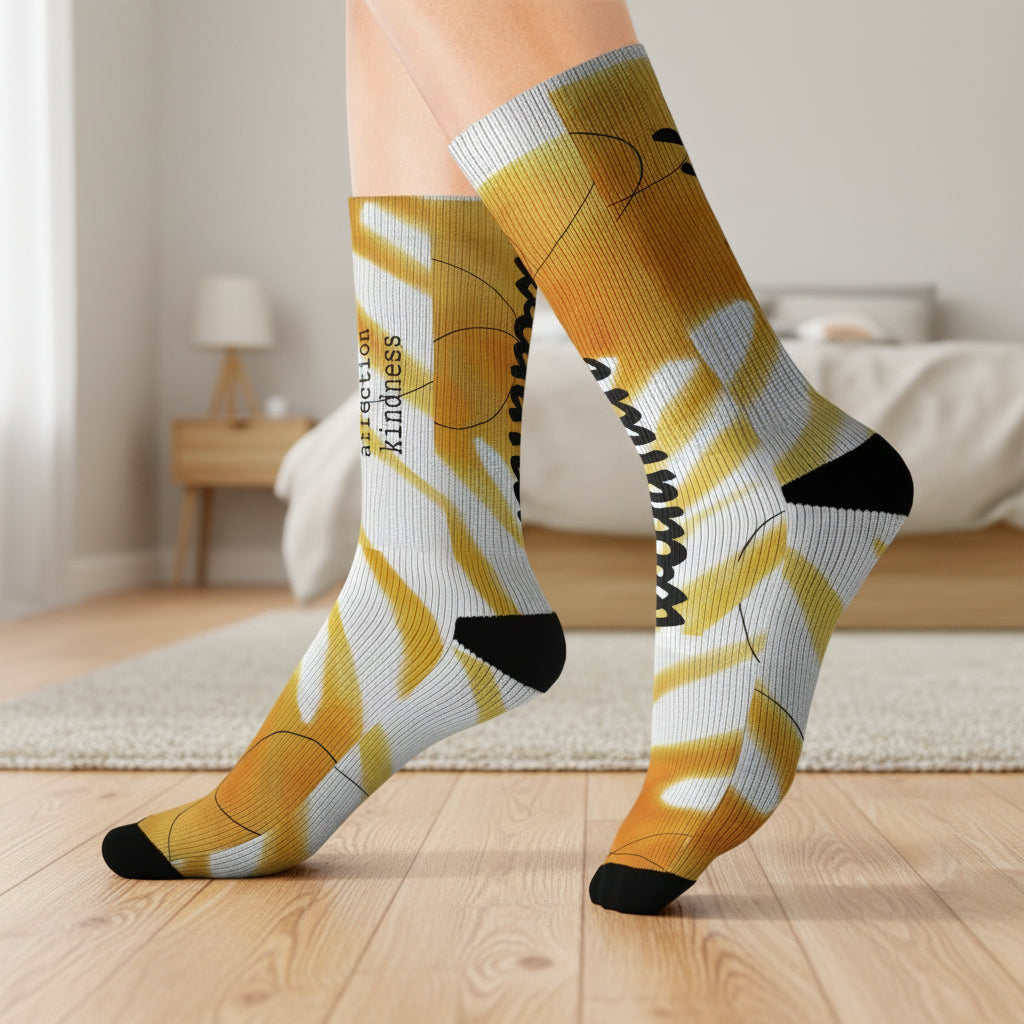 Yellow and white patterned socks with black accents in a bedroom