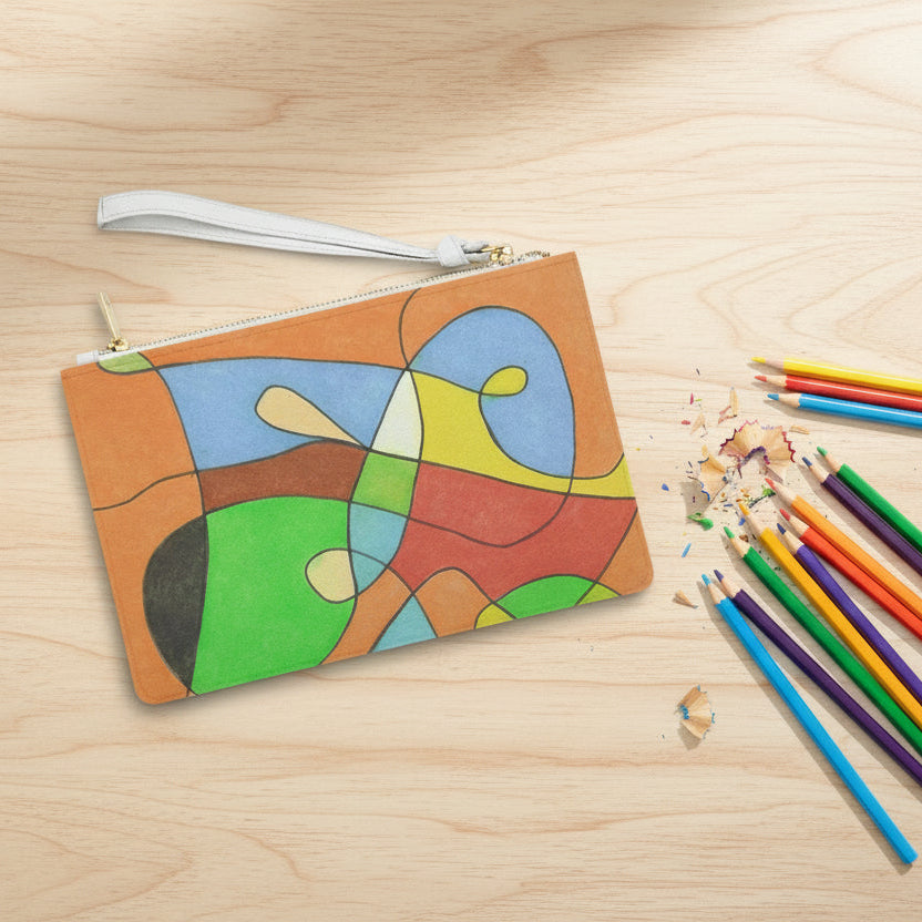 Clutch bag with colorful abstract design on a table next to some colored pencils