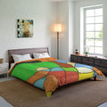 Abstract Colorful geometric patterned comforter on a bed in a well-lit bedroom.