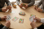 Group of people playing cards around a round table with abstract pastel art playing cards -- original art poker deck by MyLittleFe.