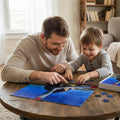 Dad and young son doing jigsaw puzzle with an airplane propeller design on a blue sky background