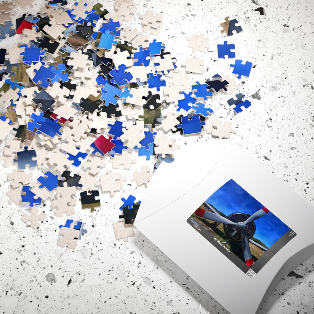 Jigsaw puzzle pieces on a surface with a completed puzzle showing an airplane propeller