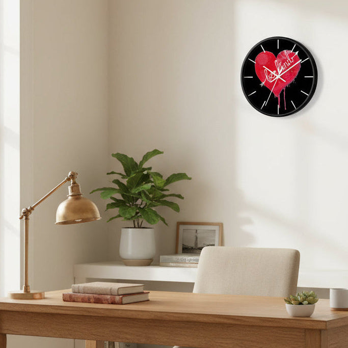 Wall clock with a red heart and 'be kind' text on a home office settig