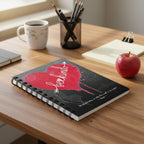 Sprial bound notebook with Bleeding heart design with Be kind text and quote from aesop on top a teacher's desk.