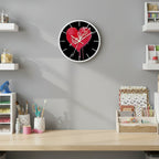 Wall clock with a red heart design and 'be kind' text on a black background
