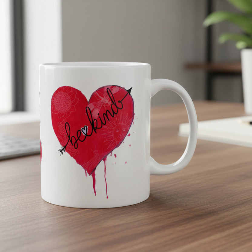 White mug with a red heart design and 'be kind' text on a white background