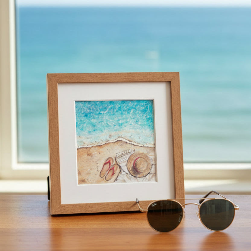 A textured beach scene artwork showing turquoise ocean water meeting a sandy shore, with a straw hat and red flip-flops resting on the sand.