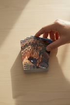 Set of playing cards with Bryce Canyong Hoodos design on the cover with a hand reaching for it