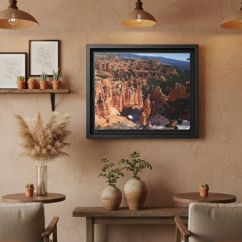 Framed photograph of Bryce Canyon with red rock formations and a black frame at a earthy cafe