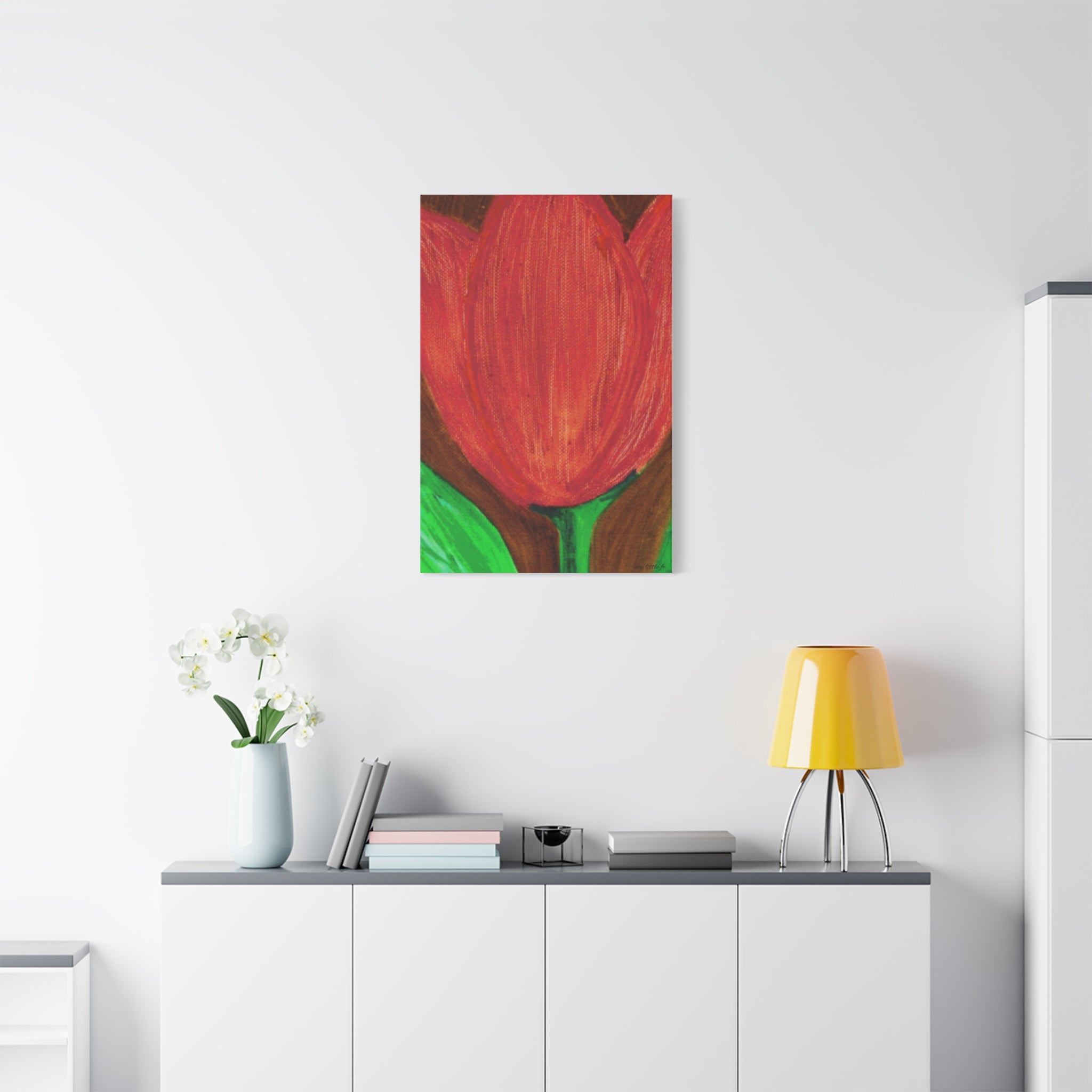 Red tulip painting on a white wall above a white cabinet with decor items.