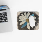 Laptop with a mouse pad featuring a daisy dragonfly design on a white surface