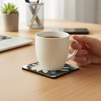 Daisy Dragonfly Wings Peters Coaster with a hand holding a coffee cup on a desk with laptop, succulent plant, phone and pen holder