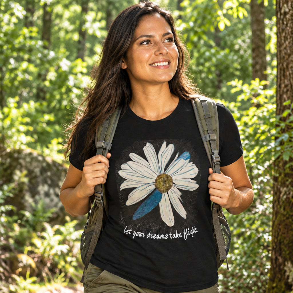 Person wearing a black t-shirt with a floral design and text in an outdoor setting