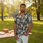 Man wearing printed shirt with Daisy Dragonfly Wings as petals design at a park with a picnic blanket behind him.