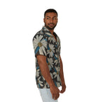 A man wearing a short-sleeve button-up shirt with a large white daisy floral print on a dark gray background, paired with light blue jeans, photographed against a solid white studio background.