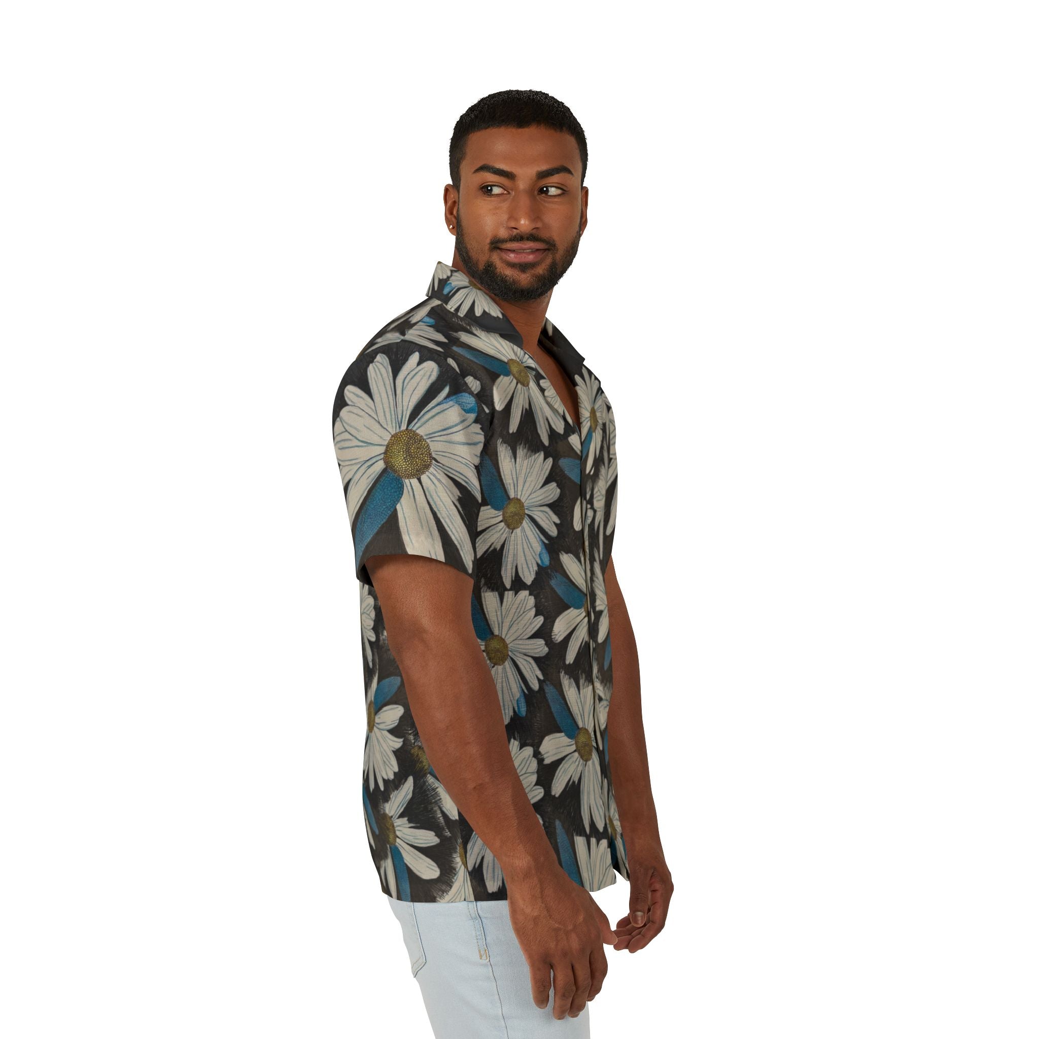A man wearing a short-sleeve button-up shirt with a large white daisy floral print on a dark gray background, paired with light blue jeans, photographed against a solid white studio background.