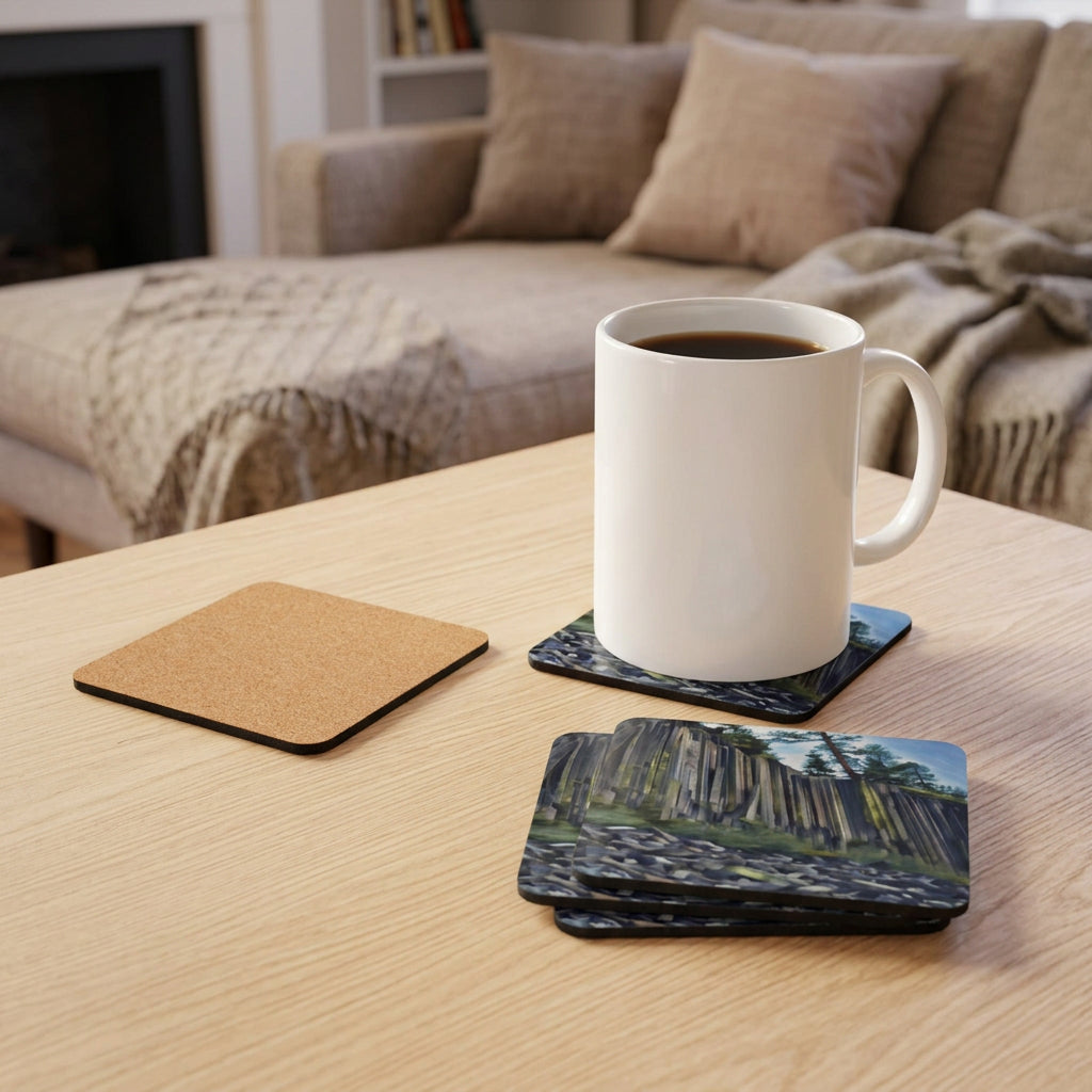 Coasters with an image of Devil's Postpile, one with a cork back, next to a white mug with coffee.