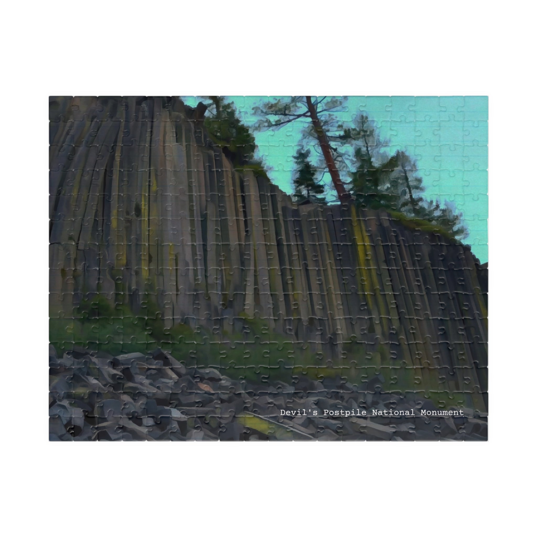 A completed jigsaw puzzle showing a landscape scene of a tall columnar rock cliff with trees and a pale blue sky, photographed against a plain white background.