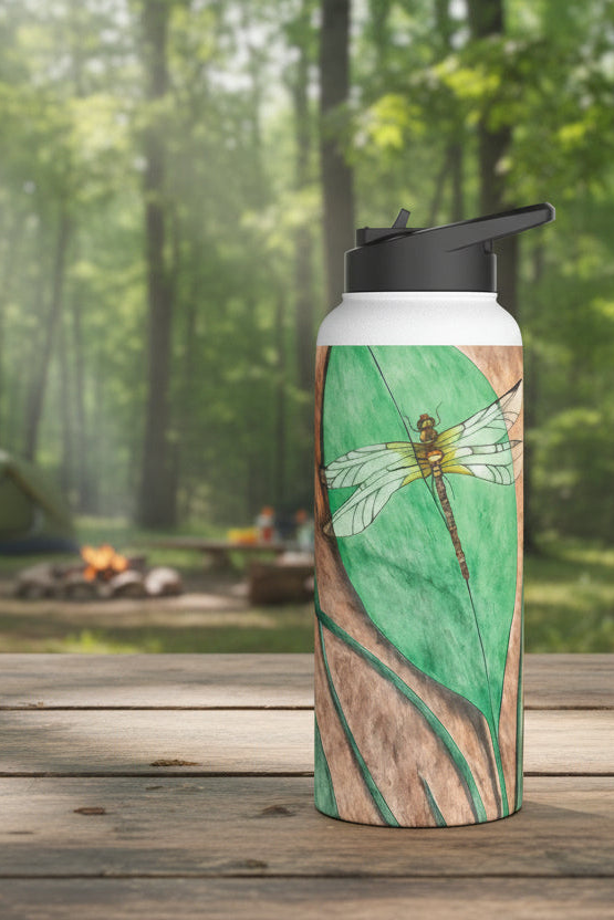 Water bottle with dragonfly design on a wooden surface with a forest background