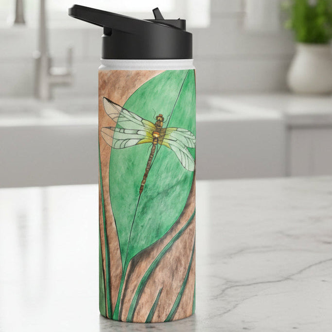 Water bottle with dragonfly on a leaf design on white marble kitchen counter