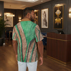 Man wearing a hawaian shirt with an oversized leaf at a restaurant front reservation area