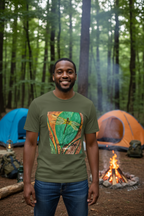 Man wearing a military green shirt with a dragonfly on a leaf design at a campground