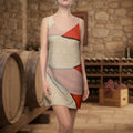Woman wearing a dress with collage of flower petals on red background with some text at a winery