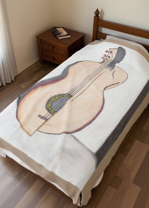 Blanket with a guitar half woman design on a bed in a bedroom setting
