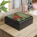 Decorative box with butterfly design on a wooden surface