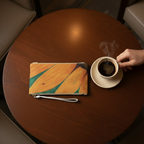 Clutch bag with Ladybug on a Sunflower design on top of a table with coffee next to it.