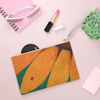 Clutch bag with a ladybug on a sunflower design with makeup notebook, succulent plant next to it