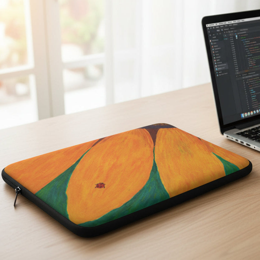 Laptop sleeve with ladybug on a sunflower on a desk with hand working on a laptop next to it