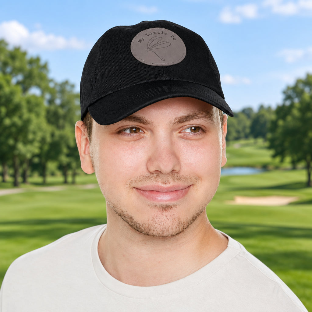 Man wearing a black cap with a logo of My Little Fe and a Dragonfly Stick drawing on a golf course