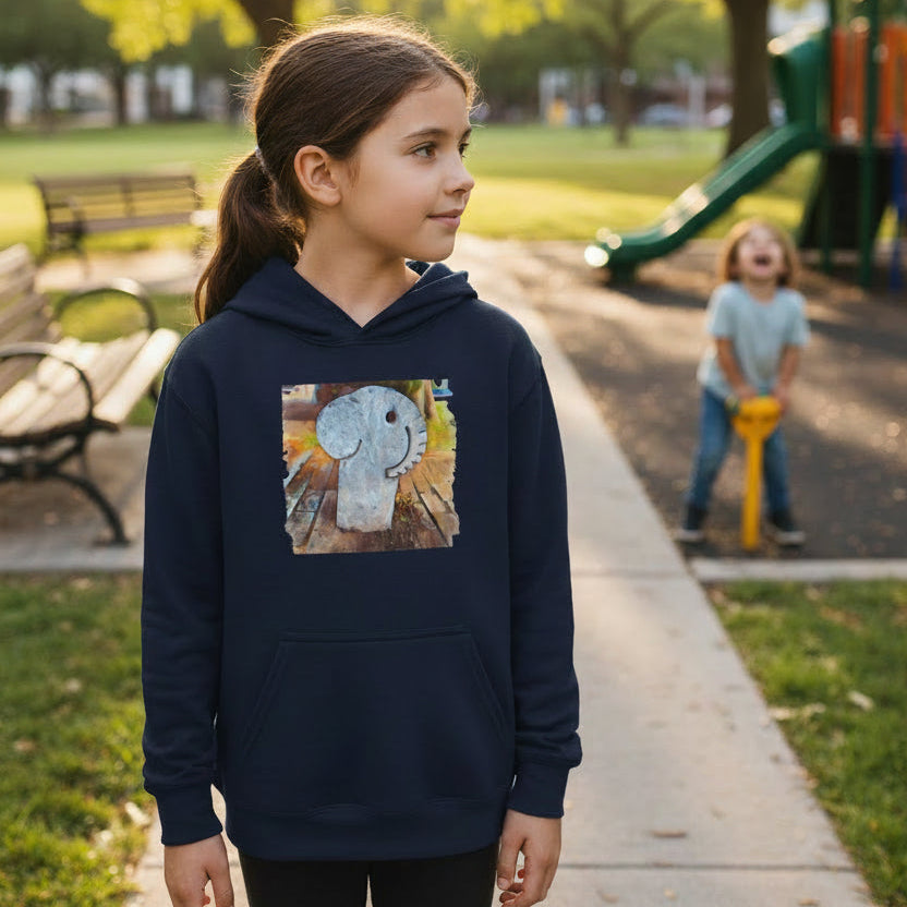A navy blue pullover hoodie with a square graphic print on the chest showing a light blue-gray stone elephant on a wooden surface with warm autumn colors.