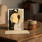 An abstract art print featuring two ravens facing each other, with a yellow-orange central space and a black-and-white yin-yang symbol above. The artwork includes Chinese characters and the word 'duality' on a textured background sitting upright on a rustic coffee table with a coffee mug next to it.