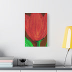 Framed artwork of a red tulip on a wall above a desk with books and a lamp.